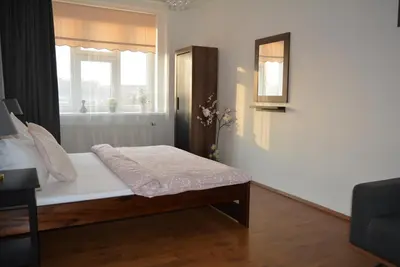 a bedroom with a bed and a window at MM Apartment Argentinska in Prague