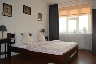 a bedroom with a bed and a window at MM Apartment Argentinska in Prague