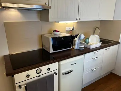 a kitchen with a microwave and a counter top at MM Apartment Argentinska in Prague