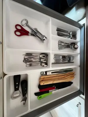 a drawer with scissors and other kitchen utensils at MM Apartment Argentinska in Prague