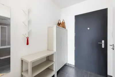 a white refrigerator with a cat sitting on top of it at Stay2gether Japandi Homestay for 4 - Metro B Luka in Prague
