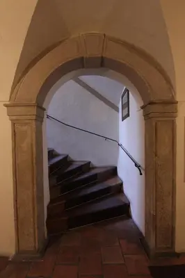 an archway with a staircase in a building at Prokopska in the heart of Mala Strana in Prague