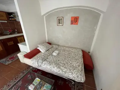 a small bedroom with a bed in the corner at Prokopska in the heart of Mala Strana in Prague