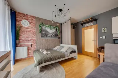 a bedroom with a bed and a brick wall at Centrum Royal Studio in Prague