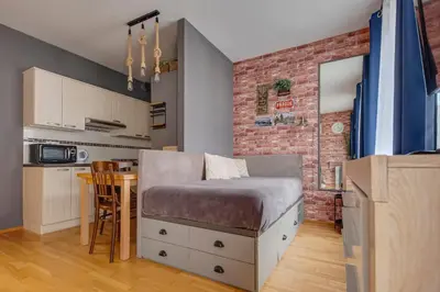 a bedroom with a bed and a brick wall at Centrum Royal Studio in Prague