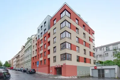 a tall red and white building on a street at Centrum Royal Studio in Prague