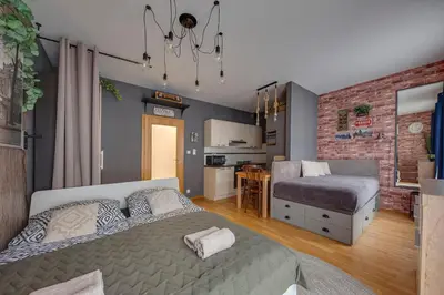 a bedroom with a bed and a kitchen in it at Centrum Royal Studio in Prague