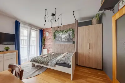 a bedroom with a bed and a brick wall at Centrum Royal Studio in Prague