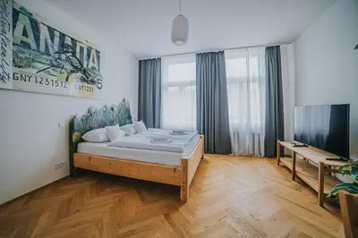a bedroom with a bed and a desk in it at Bohemian Experience in Prague