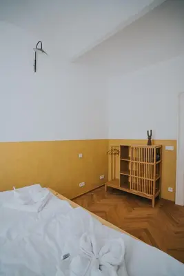 a bedroom with a white bed with a bow on it at Bohemian Experience in Prague