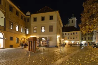 a city street at night with a building at Old Town Boutique Apartments in Prague