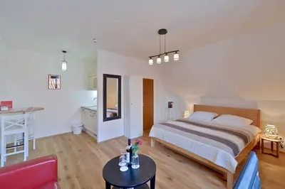 a bedroom with a bed and a table in a room at Old Town Boutique Apartments in Prague