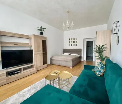 a living room with a couch and a bed at Stylish retreat in a lively area in Prague