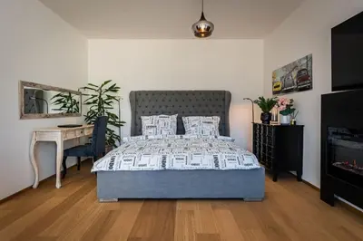 a bedroom with a bed and a table and a desk at Romantic wellness apartment in Prague