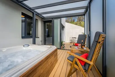 a room with a hot tub on a deck at Romantic wellness apartment in Prague