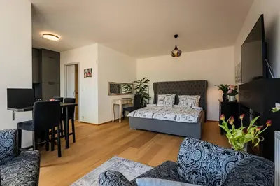 a living room with a bed and a dining room at Romantic wellness apartment in Prague