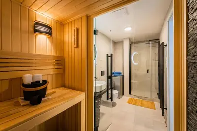a bathroom with a shower and a toilet and a sink at Romantic wellness apartment in Prague