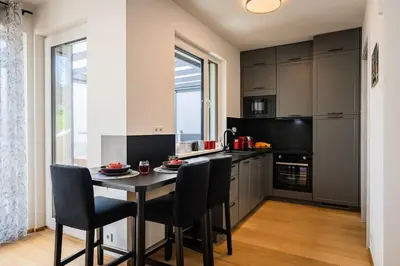 a kitchen with a table and chairs and a window at Romantic wellness apartment in Prague