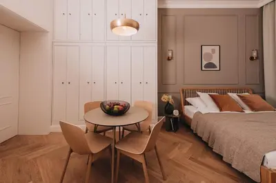 a bedroom with a bed and a table and chairs at Stylish new apartment in Prague with A/C in Prague