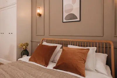 a bedroom with a bed with brown and white pillows at Stylish new apartment in Prague with A/C in Prague