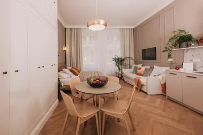 a kitchen and living room with a table and a couch at Stylish new apartment in Prague with A/C in Prague