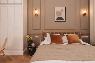a bedroom with a large bed and a chair at Stylish new apartment in Prague with A/C in Prague