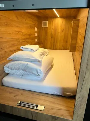 two beds in a room with wooden walls at Like a Hostel Prague in Prague