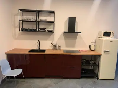 a kitchen with a counter and a sink and a refrigerator at Like a Hostel Prague in Prague
