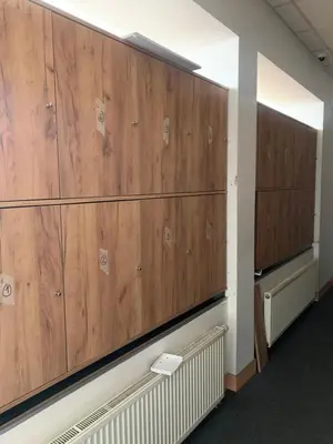 a row of wooden lockers in a room at Like a Hostel Prague in Prague