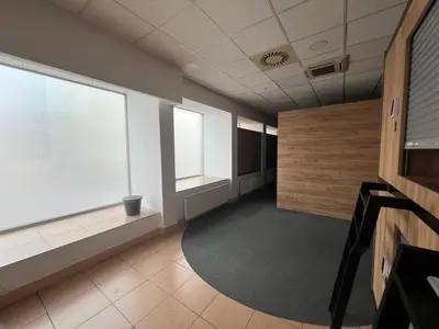 an empty hallway in an office building with windows at Like a Hostel Prague in Prague