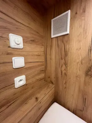 a room with a wooden wall with a bed and a heater at Like a Hostel Prague in Prague
