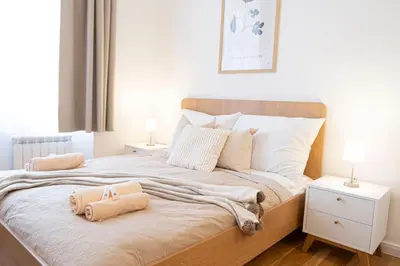 a bedroom with a large bed with two night stands at Rentero Varsavska Apartment Residence, Prague in Prague