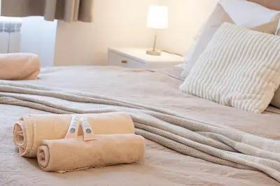 a bedroom with two towels on a bed at Rentero Varsavska Apartment Residence, Prague in Prague