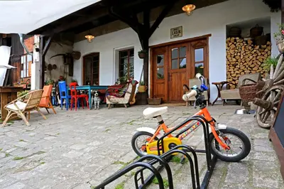 an orange bike parked in front of a house at Penzion U Lasíků in Únětice