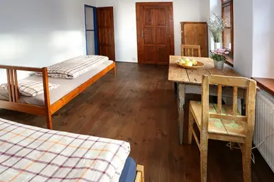 a room with a bed and a table with a tableablish at Penzion U Lasíků in Únětice