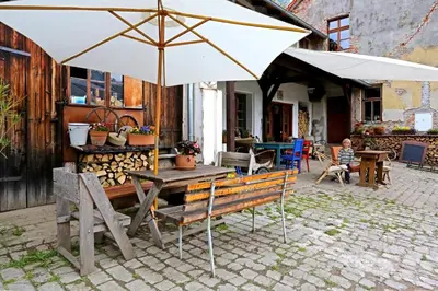 a table with an umbrella on a patio at Penzion U Lasíků in Únětice
