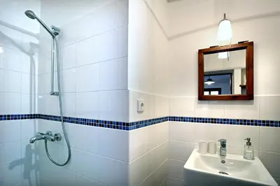 a bathroom with a shower and a sink and a mirror at Penzion U Lasíků in Únětice