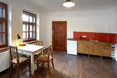 a kitchen with a table and chairs and a sink at Penzion U Lasíků in Únětice