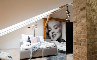 a living room with a couch and a brick wall at Rentero Marilyn Monroe Apartment with AC in Prague center in Prague