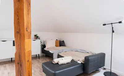 a bedroom with a bed and a ottoman in front of it at Rentero Marilyn Monroe Apartment with AC in Prague center in Prague