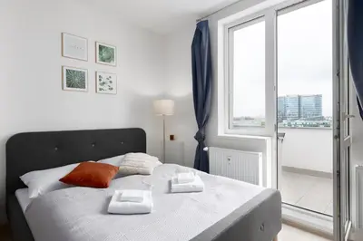 a bedroom with a bed with two towels on it at Apartment near the subway with a terrace in Prague