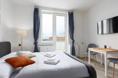 a bedroom with a bed with towels on it at Apartment near the subway with a terrace in Prague