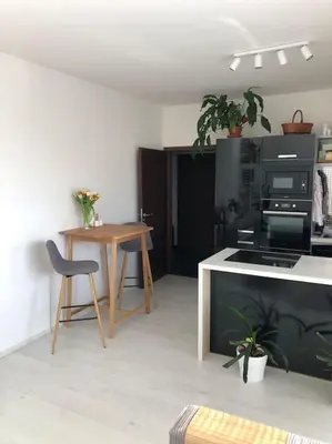 a kitchen with a table and a table and a table and a chair at Apartment Little Hill in Prague