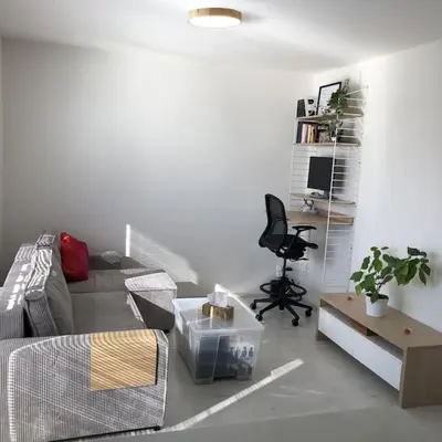 a living room with a couch and a chair at Apartment Little Hill in Prague