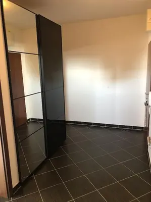 an empty room with glass doors and a tiled floor at Apartment Little Hill in Prague