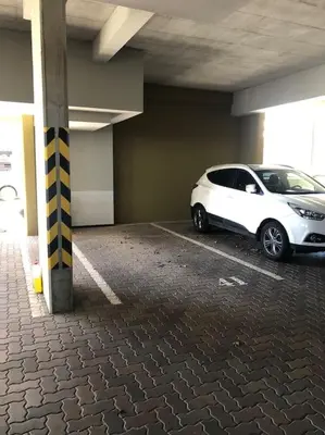 a white car parked in a parking garage at Apartment Little Hill in Prague