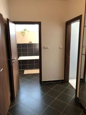 a bathroom with a door open to a bathroom with a tub at Apartment Little Hill in Prague