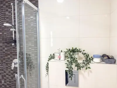 a white bathroom with a toilet and a shower at Praha 1 Florenc Hlavní mesto Romantic Apartments in Prague