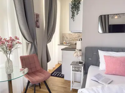 a kitchen with white cabinets and a microwave at Praha 1 Florenc Hlavní mesto Romantic Apartments in Prague