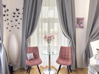 two chairs and a glass table with a vase of flowers at Praha 1 Florenc Hlavní mesto Romantic Apartments in Prague